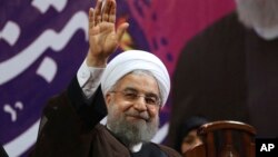 FILE - Iranian President Hassan Rouhani, center, waves to his supporters during a campaign rally for the May 19 presidential election in Tehran, Iran, May 9, 2017. 