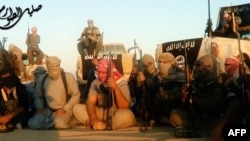 An image grab taken from a propaganda video uploaded on June 8, 2014, by the jihadist group the Islamic State of Iraq and the Levant [ISIL] allegedly shows ISIL militants gathered near Tikrit, Iraq.