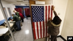 Election workers set up voting booths at Memorial Elementary School in Little Ferry, New Jersey, Nov. 6, 2012. 