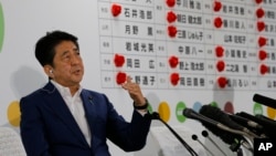 Japan's Prime Minister Shinzo Abe, leader of the Liberal Democratic Party, answers questions during a TV interview at their party headquarters in Tokyo, Sunday, July 10, 2016. (AP Photo/Shizuo Kambayashi)