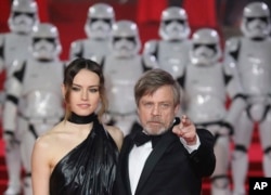 FILE - Actors Daisy Ridley and Mark Hamill pose for photographers upon arrival at the premiere of "Star Wars: The Last Jedi" in London, Dec. 12, 2017.