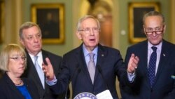 FILE - Senate Minority Leader Harry Reid of Nevada, center, talks to reporters on Capitol Hill in Washington, March 1, 2016.