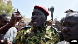 Lieutenant-Colonel Yacouba Issaac Zida (C) leaves the Place de la Nation square on October 31, 2014 in Ouagadougou after the resignation of Burkina Faso's President Blaise Compaore.