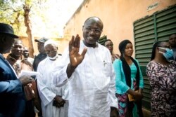 FILE - Burkina Faso opposition candidate Eddie Komboïgo votes in elections in Ouagadougo, Nov. 22, 2020.