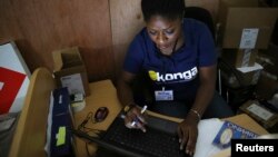 FILE - A staff member inputs data into a computer at a warehouse of Konga online shopping company in Ilupeju district in Nigeria's commercial capital Lagos Sept. 13, 2013.