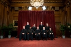 Members of the Supreme Court pose for a group photo at the Supreme Court in Washington, Friday, April 23, 2021.