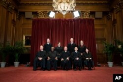 Members of the Supreme Court pose for a group photo at the Supreme Court in Washington, Friday, April 23, 2021.