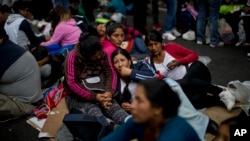 Demonstrators sit on a street during a protest in Buenos Aires, Argentina, March 15, 2017. People are protesting to demand more social help from Mauricio Macri's government. 