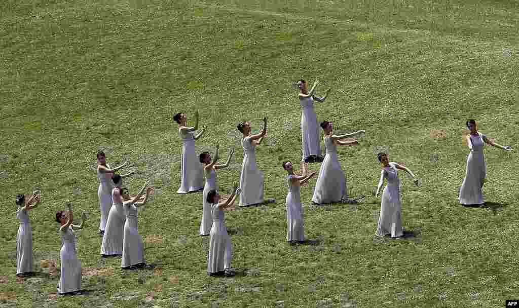 Actresses, playing the role of priestesses, take part in the torch lighting ceremony of the London 2012 Olympic Games. (Reuters)