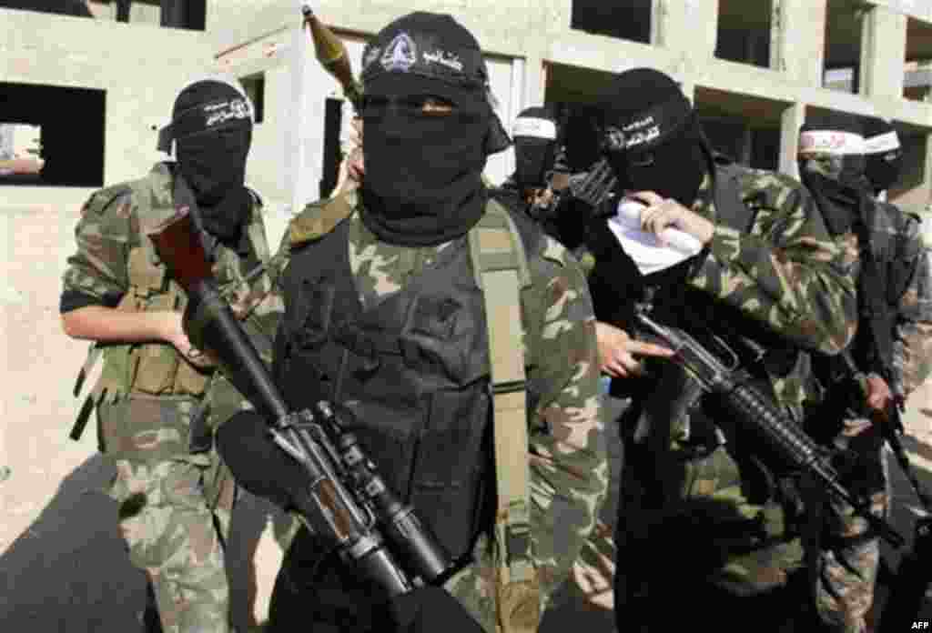 Masked Palestinian militants of the Hamas-allied Popular Resistance Committees, prepare to hold a press conference marking the 2nd anniversary of the Israel-Gaza war, in Gaza City, Monday, Dec. 27, 2010. Israel's volatile front with Gaza has been relative