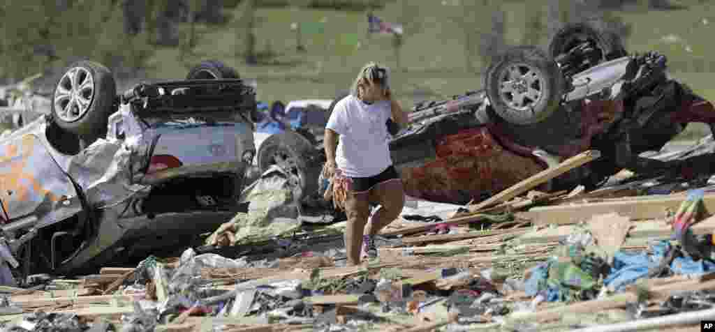 Connie Krehel looks through debris after her home was hit by a tornado, April 28, 2014, in Vilonia, Arkansas. 