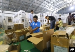Workers prepare ballot boxes to be distributed to polling stations in Jakarta, Indonesia, Apr. 15, 2019.