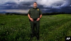 U.S. Border Patrol Agent Richard Ross, poses for a portrait in a field where people entering the United States illegally from Canada have been apprehended, in Derby Line, Vermont, July 10, 2018.