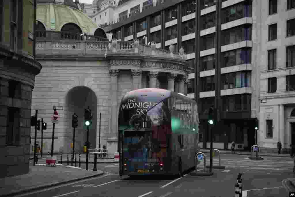 A bus drives through the City of London financial district in London, on the first morning of England entering a third national lockdown since the coronavirus outbreak began.
