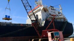 FILE: Workers unload the Isadora at The Port Of Cleveland on April 4, 2012, in Cleveland. The Isadora travaled from the Netherlands with 11,348 tons of steel coils and took 14 days before arriving in Cleveland.