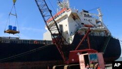 FILE: Workers unload the Isadora at The Port Of Cleveland on April 4, 2012, in Cleveland. The Isadora travaled from the Netherlands with 11,348 tons of steel coils and took 14 days before arriving in Cleveland.