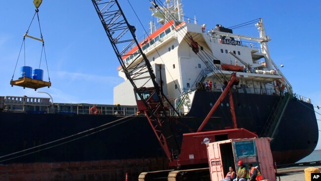 FILE: Workers unload the Isadora at The Port Of Cleveland on April 4, 2012, in Cleveland. The Isadora travaled from the Netherlands with 11,348 tons of steel coils and took 14 days before arriving in Cleveland.