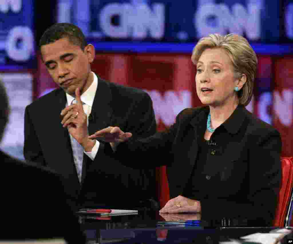 Sen. Barack Obama, D-Ill., left, gestures for time as Sen. Hillary Rodham Clinton, D-N.Y., responds to a question during a Democratic presidential debate in Los Angeles, Thursday, Jan. 31, 2008. (AP Photo/Chris Carlson)