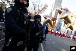 Members of the New York Police Department take a position along the route before the start of the 92nd annual Macy's Thanksgiving Day Parade in New York, Nov. 22, 2018.