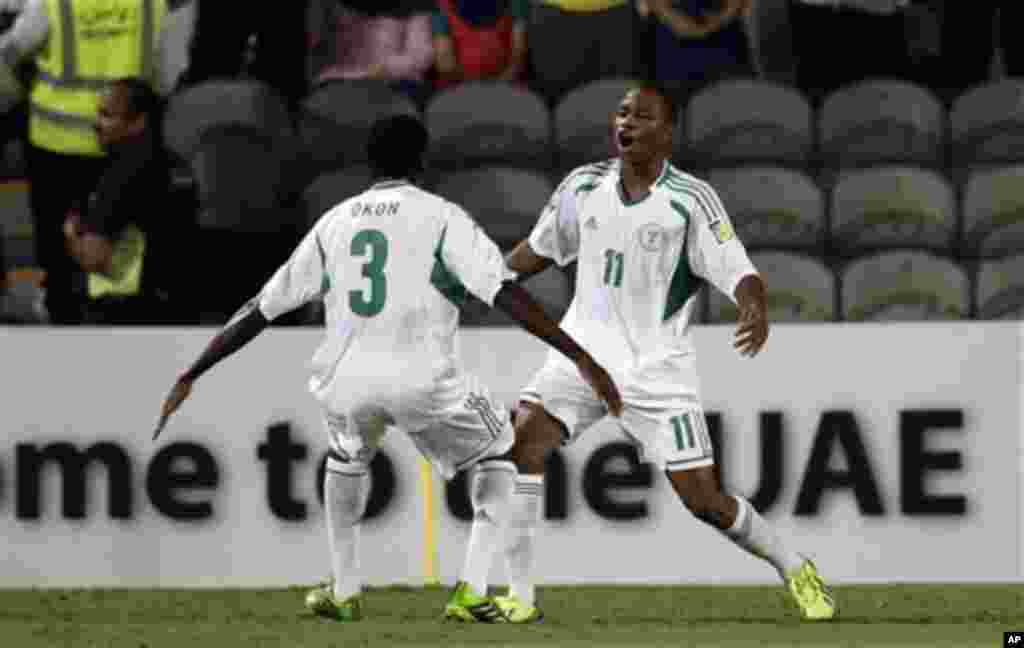 Nigeria's Musa Yahaya, right, celebrates scoring the opening goal with his teammate Samuel Okon against Mexico during the World Cup U-17 final soccer match between Nigeria and Mexico at Mohammad Bin Zayed stadium in Abu Dhabi, United Arab Emirates, Friday