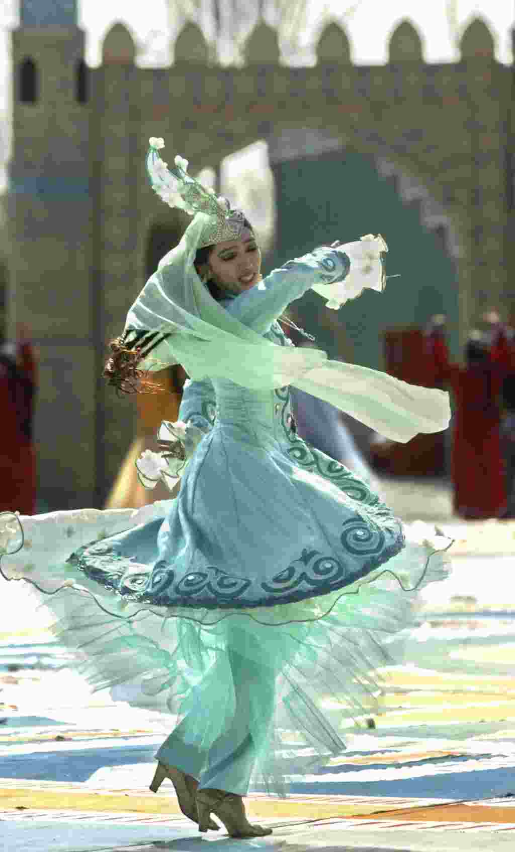 A dancer wearing traditional Uzbek costume performs during a celebration to mark the upcoming Persian New Year, known as Nowruz, in the Uzbek capital Tashkent, Sunday, March 19, 2002. Nowruz is observed across Central Asia and in Iran on the first day o