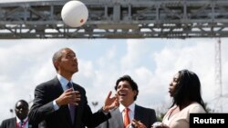 FILE - U.S. President Barack Obama bounces a soccer ball with his head at Ubungo Power Plant in Dar es Salaam, July 2, 2013. The ball, called a "soccket ball," has internal electronics that allow it to generate and store electricity that can power small devices.