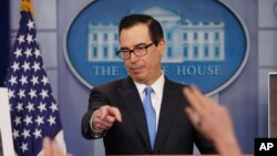 Treasury Secretary Steve Mnuchin gestures as he answers questions during a press briefing at the White House in Washington, Feb. 23, 2018. 