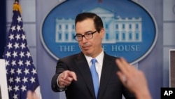 FILE - Treasury Secretary Steve Mnuchin gestures as he answers questions during a press briefing at the White House in Washington.