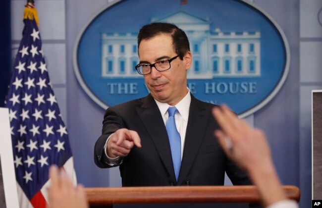 FILE - Treasury Secretary Steve Mnuchin gestures as he answers questions during a press briefing at the White House in Washington, Feb. 23, 2018.