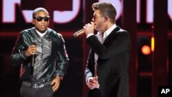 FILE - Pharrell Williams, left, and Robin Thicke perform onstage at the BET Awards June 30, 2013.