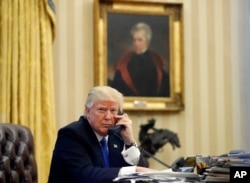 FILE - In this Jan. 28, 2017, file photo, President Donald Trump speaks on the telephone with Australian Prime Minister Malcolm Turnbull in the Oval Office of the White House in Washington.