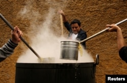 Volunteers cook soup called 'porciuncula' during a religious activity at the convent of Los Descalzos, in Lima, Peru, August, 2017.