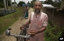 Abdul Manan, a Muslim man returns after finding that his name is not included in the National Register of Citizens draft in Mayoung, about 55 kilometers (34 miles) east of Gauhati, India, July 30, 2018.