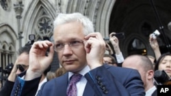 WikiLeaks founder Julian Assange leaves the High Court after two judges deferred a decision over whether to allow Assange to be extradited to Sweden from Britain over allegations of sexual misconduct, in London, July 13, 2011