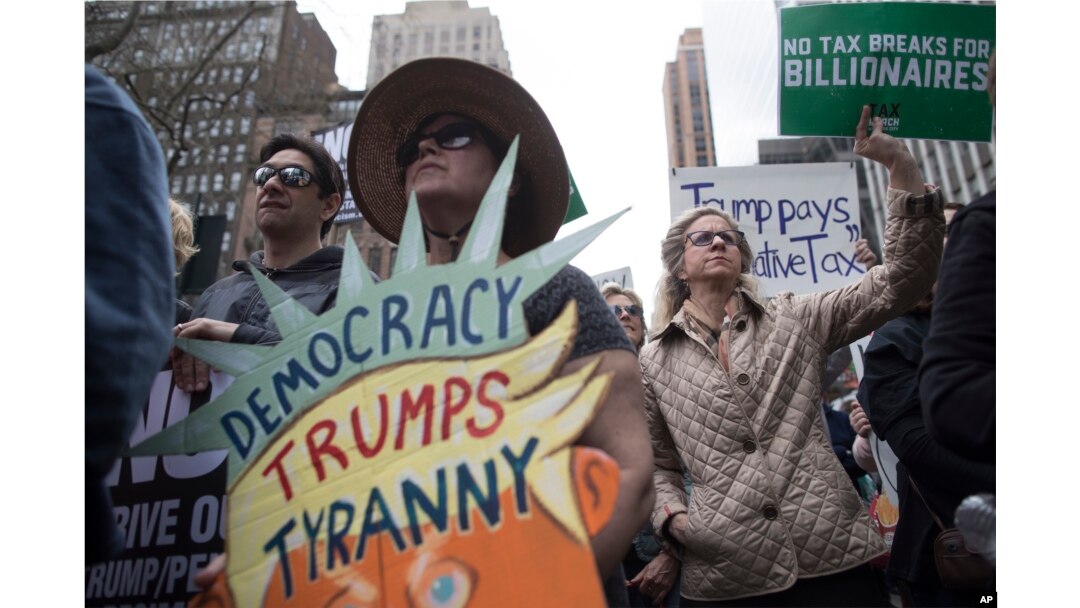 Demonstrators participate in a march and rally to demand President Donald Trump release his tax returns in New York, April 15, 2017.