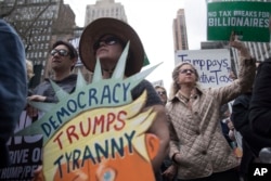 Demonstrators participate in a march and rally to demand President Donald Trump release his tax returns in New York, April 15, 2017.