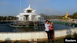 A couple takes a self-portrait at People's Square on Valentine's Day near Shwedagon pagoda in Rangoon, Feb. 14 , 2014. 