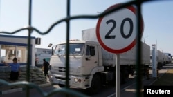 Trucks from a convoy that delivered humanitarian aid for Ukraine move back to Russia, Aug. 23, 2014. 