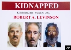 FILE- An FBI poster showing a composite image of former FBI agent Robert Levinson (right) of how he would have looked after five years in captivity, and an image (center) taken from the video, released by his kidnappers, and a picture before he was kidnapped, released on March 6, 2012.