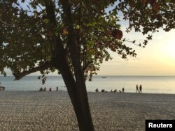 Tourists play at a beach front at the Preah Sihanoukville province, Cambodia, Nov. 26, 2017.