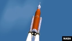 This illustration made available by NASA shows the Space Launch System during liftoff. On Wednesday, March 13, 2019, NASA's top official said the space agency's new rocket won't be ready for a moon shot next year. (Marshall Space Flight Center/NASA via AP)