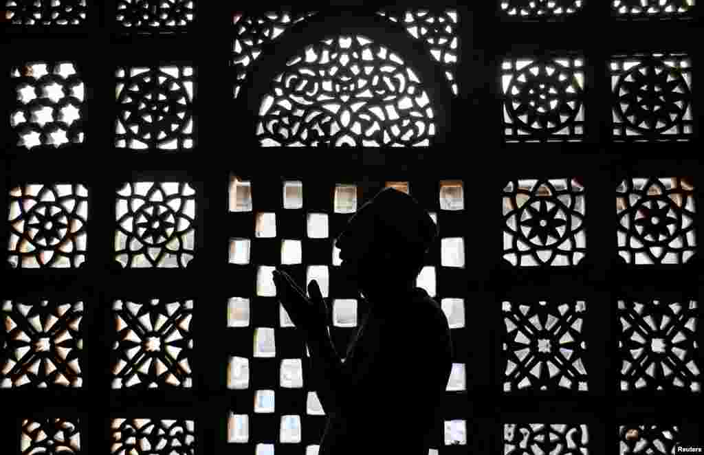 A Muslim man prays inside a shrine during the holy fasting month of Ramadan in Ahmedabad, India.