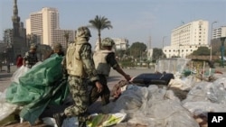Egyptian Army soldiers remove tents of protesters from Tahrir Square in Cairo, Egypt, Sunday, Feb. 13, 2011. Egypt's military has started taking down the makeshift tents of protesters who camped out on Tahrir Square in an effort to allow traffic and norma