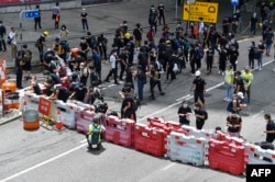 抗议者2019年6月21日占据了香港政府总部外的一条主要道路。数百名黑衣人士封锁了香港议会外的一条高速公路，要求亲北京的香港特首辞职。