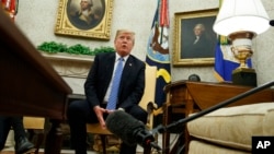 President Donald Trump speaks to the media in the Oval Office of the White House, in Washington, July 2, 2018.