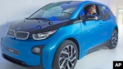 Harald Krueger, CEO of car manufacturer BMW, sits in a BMW i3 car after after it left the assembly line during the production anniversary of the 100,000th electric car at the plant of German luxury automaker BMW.