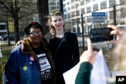 Chelsea Manning, right, poses for a photograph with the Rev. Annie Chambers, a Green Party candidate for Maryland Lieutenant Governor, at an anti-fracking rally in Baltimore, Maryland, April 18, 2018.