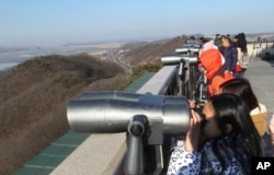 Visitors watch the North Korean side at the unification observation post near the border village of Panmunjom, which has separated the two Koreas since the Korean War, in Paju, South Korea, Feb. 7, 2016.