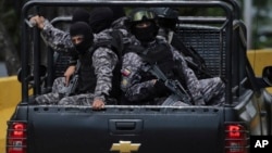 Members of the Venezuelan Bolivarian Intelligence Service arrive to the Junquito highway during an operation to capture Oscar Perez in Caracas, Venezuela, Jan. 15, 2018.