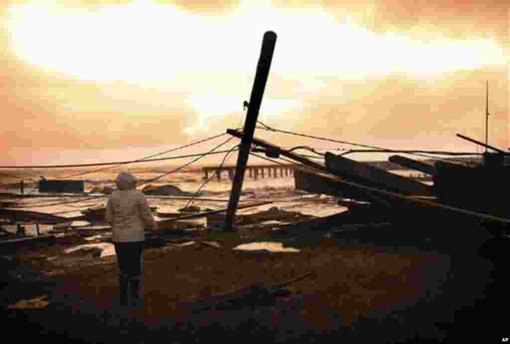 Kim Johnson looks at the destruction left by Sandy near her seaside apartment in Atlantic City, New Jersey, October 30, 2012. 